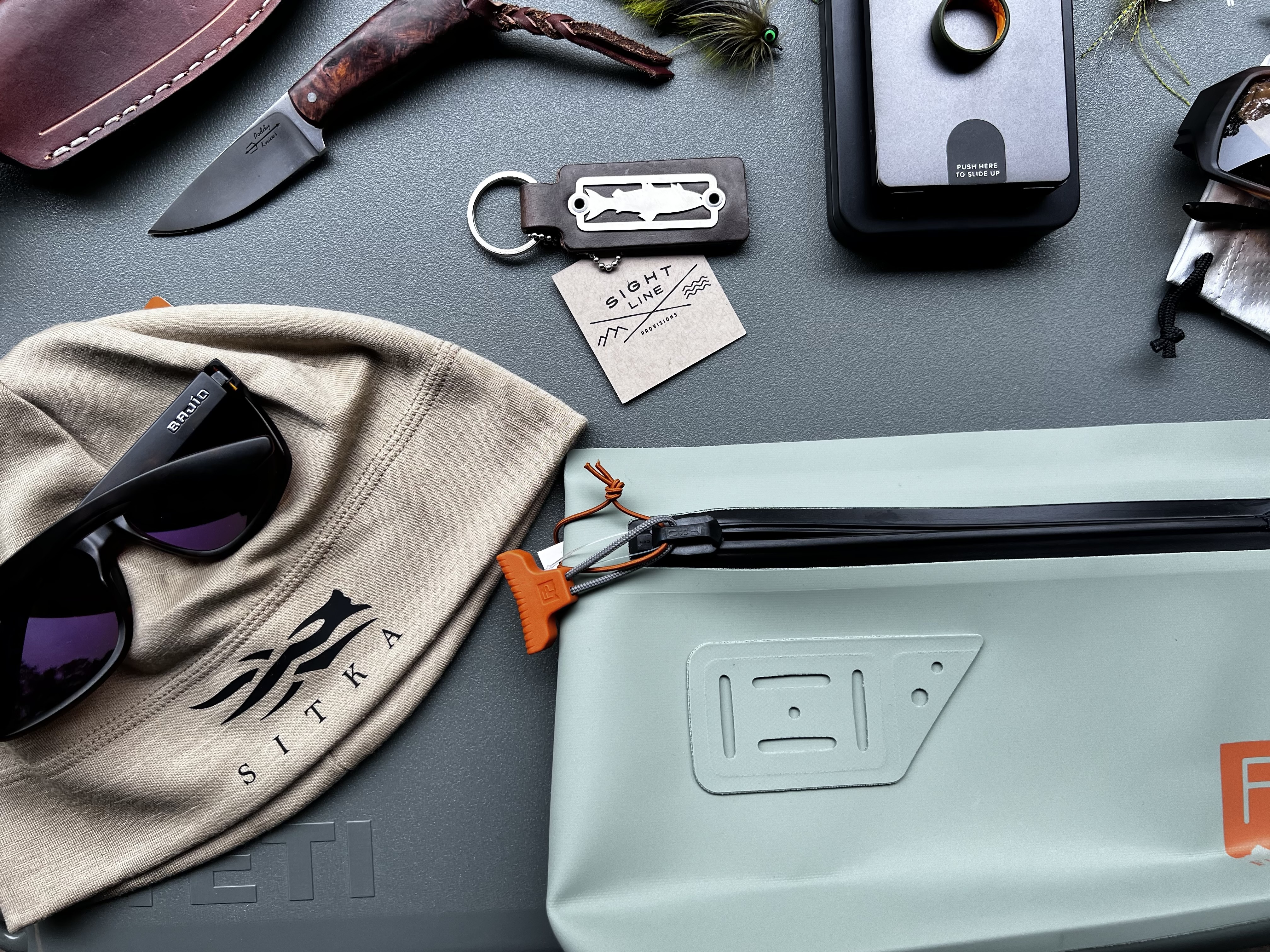 Outdoor gear display featuring tactical, hunting, and fly fishing equipment, sold at Sportsman's Finest in Austin, Texas.