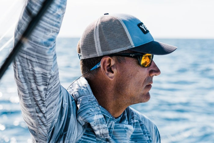 Angler in salt water getting ready to cast lines overlooking the view in Maui Jim sunglasses