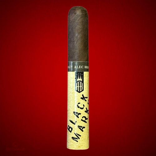 Alec Bradley Black Market Robusto cigar on red background at Boisdale