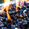 The illusion effect of flames "melting" midnight black fire glass