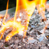 Close up of reflective silver fire glass in a gas fire pit.