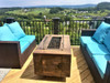 Fire table with wind guard on outdoor patio