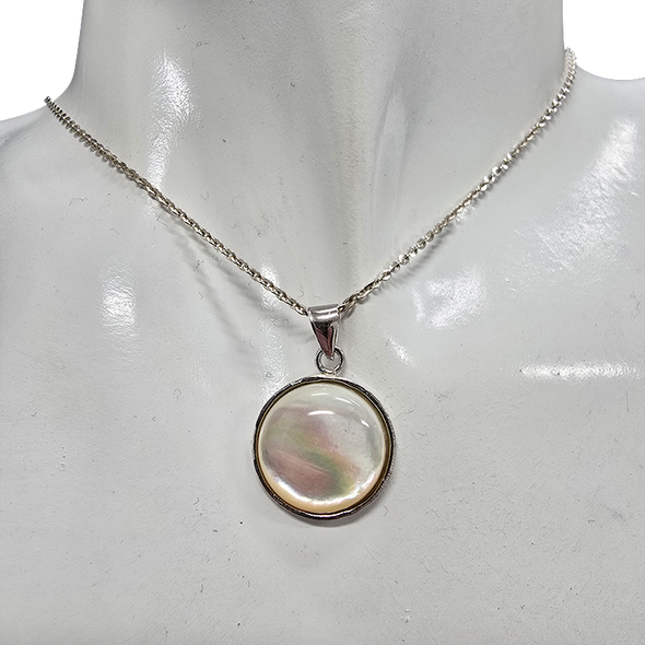 Mother of Pearl Sterling Silver Pendant.
A round mother-of-pearl shell is set in .925 sterling silver.