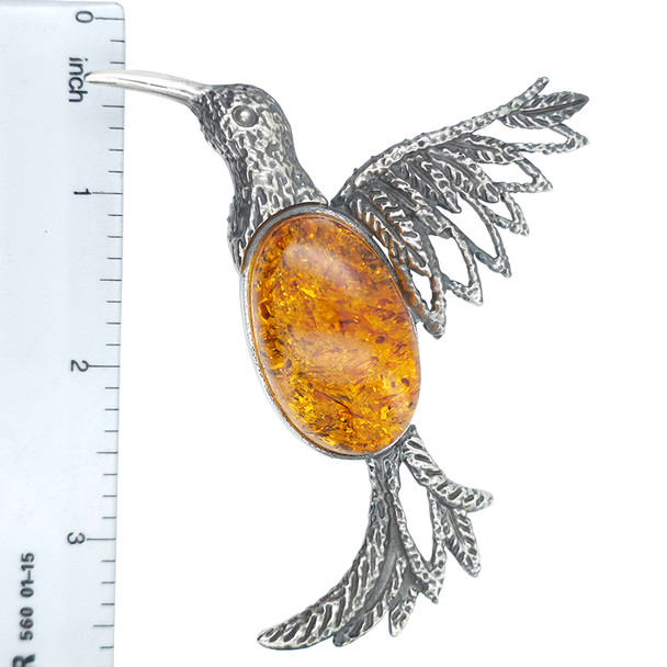 Cognac Amber Sterling Silver Hummingbird Handmade Pendant. An oval-shaped genuine Baltic amber stone is set in .925 sterling silver. Handcrafted hummingbird design.