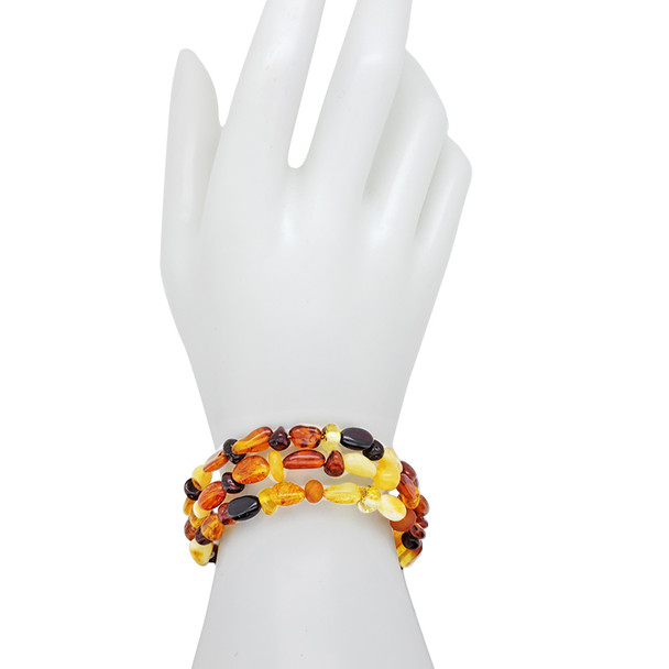 Multi-color amber memory wire bracelet. Round, olive and free-shaped amber beads are set on a wire. Genuine Baltic amber.