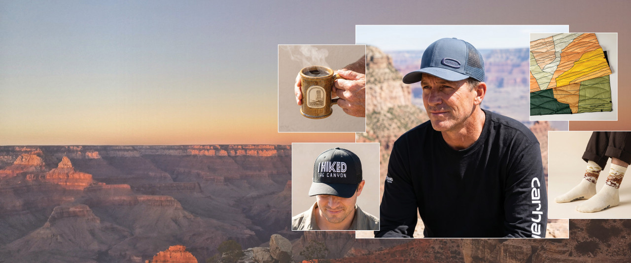 Man in a carhartt shirt and hat surrounded by Grand Canyon inspired mug, socks, hat, and blanket.