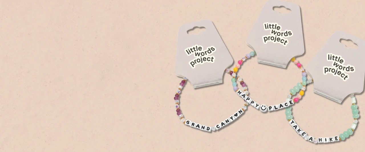3 beaded bracelets on a tan background that say Grand Canyon, Happy Place, Take A Hike.