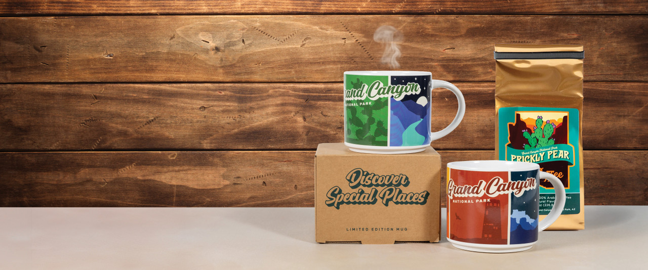 Various Grand Canyon mugs with steam coming out of them sitting beside a bag of prickly pear coffee on a countertop.