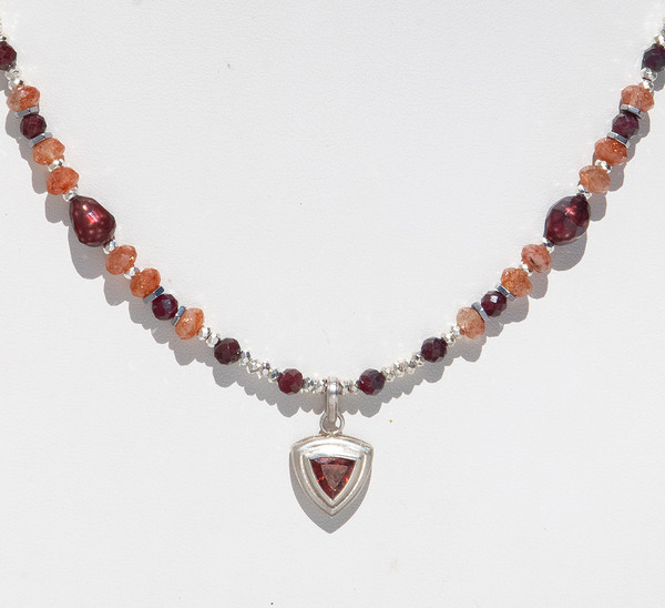 Show Item AG32 - Garnet And Sunstone Power And Direction Necklace. Silver pendant. 