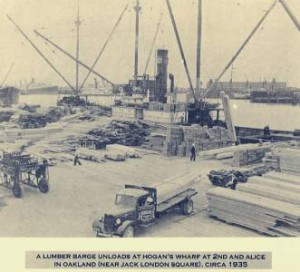 A lumber barge unloading at Hogan's Wharf