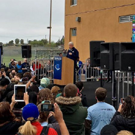 Former president Bill Clinton standing at a podium