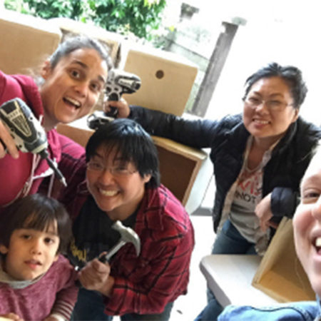Group of women and girls holding tools