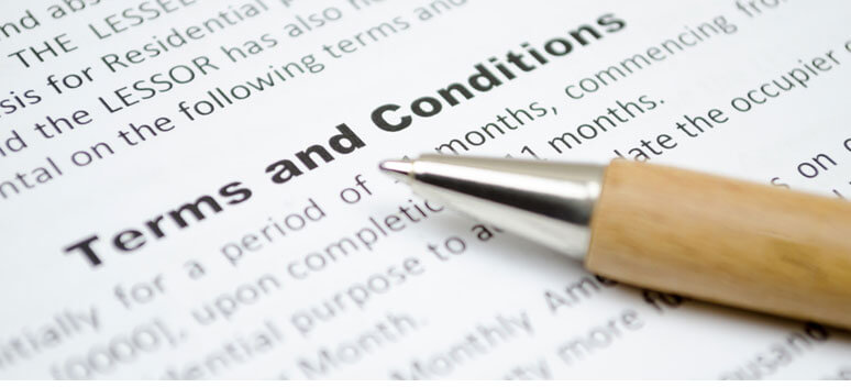 Pen sitting on terms and liability document