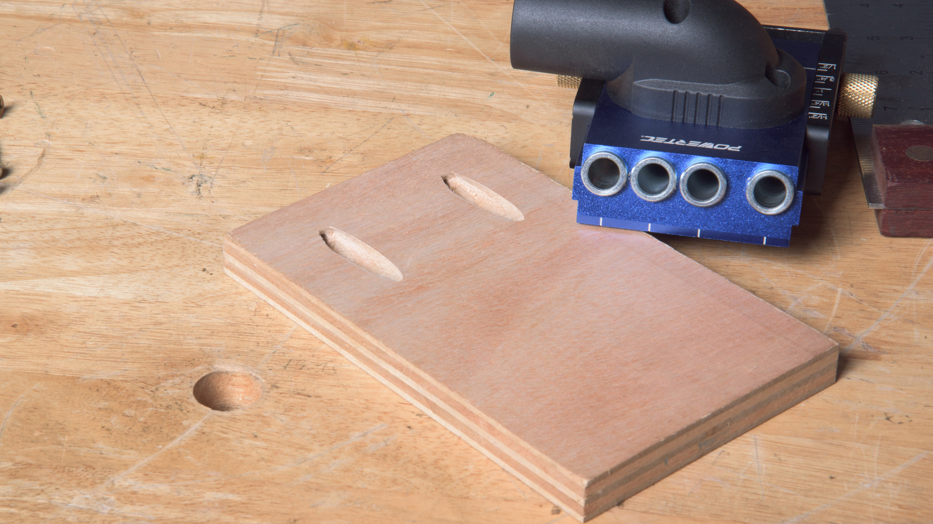 POWERTEC pocket hole jig drilling an angled hole with a step drill bit and stop collar