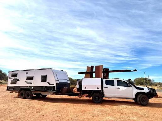 Pickup truck towing a loaded trailer with heavy duty suspension
