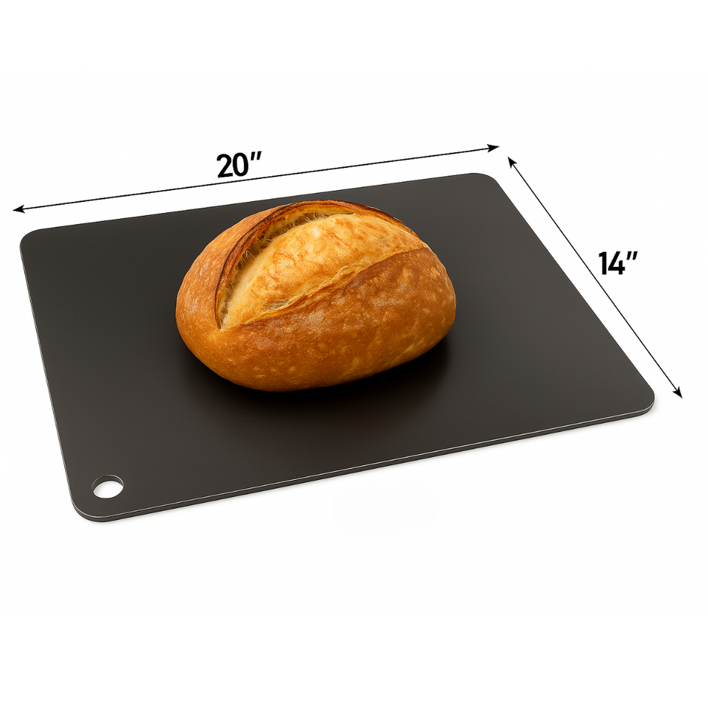 Freshly baked round artisan bread resting on a black Cooking Steel baking surface.