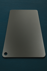 Close-up of a black Cooking Steel baking plate, designed for high-heat bread and pizza baking.