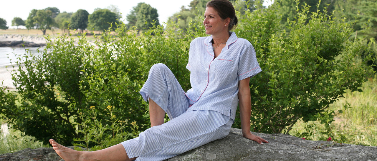 Woman sitting outdoors wearing seersucker short sleeve pajamas