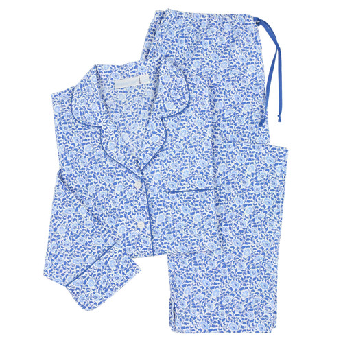 Women's cotton poplin button-down long sleeve pajamas.  Printed with small, repeating blue and white floral pattern. Two-piece pajama set lying flat.