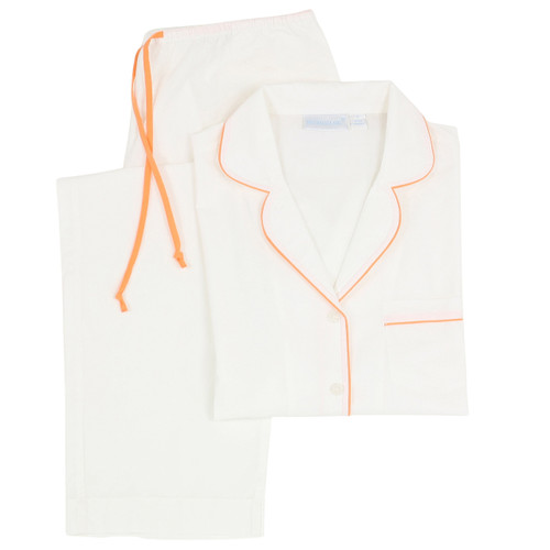 Women's white cotton pajama set with orange piping and pant ties. Long sleeve, two-piece set folded flat.