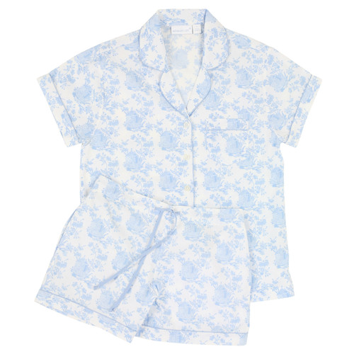 Women's cotton poplin button-down short sleeve shorty pajama set trimmed with blue piping. Printed in a blue and white toile design. Two-piece pajama set lying flat.