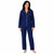 Woman standing wearing solid navy cotton pajama set with white trim. Long sleeve, two-piece set.