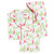 Women's printed cotton pajama set in a red and green holiday print. Long sleeve, two-piece set folded flat. Women's printed cotton pajama set in a red and green holiday print. Long sleeve, two-piece set folded flat.