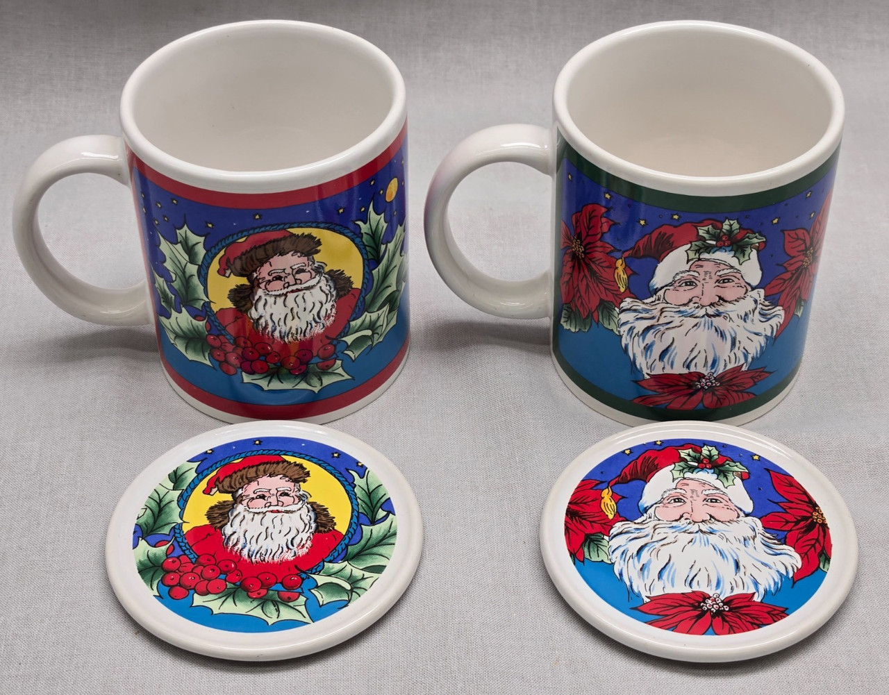 Set Of 2 Action Christmas Santa Mugs with Coasters/Lids Set Of 2 Action Christmas Santa Mugs with Coasters/Lids