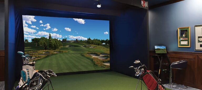 A completed golf simulator setup with golf bags in front