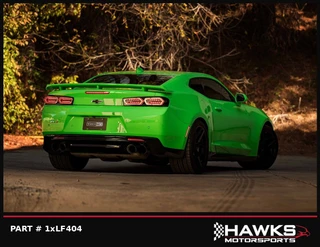  Rear three-quarter view of a green Camaro with Morimoto LF404 smoked tail lights installed. Hawks Motorsports frame labeled PART # 1xLF404.