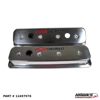 Pair of polished aluminum Chevrolet center-bolt valve covers with red bowtie emblems and black Chevrolet lettering, angled view, part 12497978.