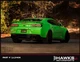  Rear three-quarter view of a green Camaro with Morimoto LF404 smoked tail lights installed. Hawks Motorsports frame labeled PART # 1xLF404.