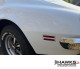 Rear side marker lamp bezel installed on the driver-side quarter panel of a second-generation Pontiac Firebird