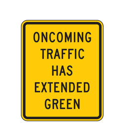 Oncoming Traffic Has Extended Green Warning Signs
