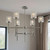 Silver Candle Style Six Light Metal Dimmable Chandelier With Clear Shades Silver Candle Style Six Light Metal Dimmable Chandelier With Clear Shades