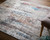 8' X 11' Gray Blue and Red Abstract Power Loom Area Rug With Fringe 8' X 11' Gray Blue and Red Abstract Power Loom Area Rug With Fringe