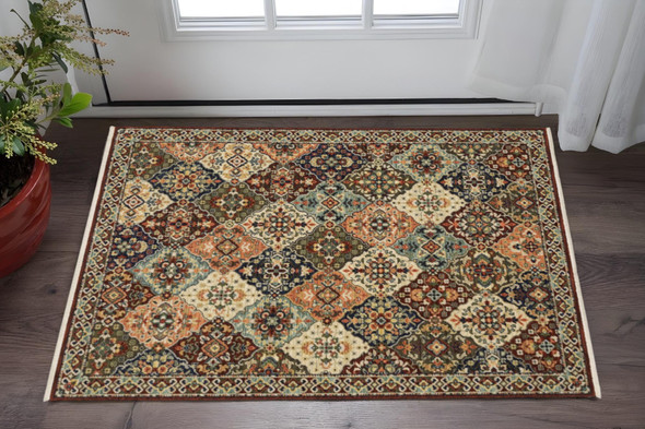 2' X 3' Red Rust Navy Light Blue Brown Orange Ivory And Gold Oriental Power Loom Stain Resistant Area Rug With Fringe