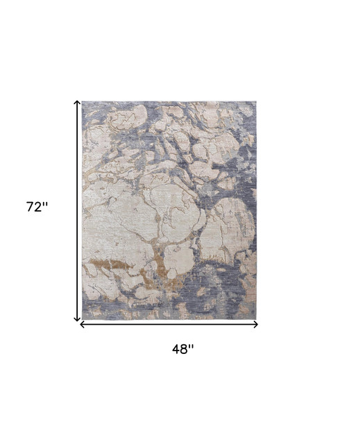 4' X 6' Tan Blue And Beige Abstract Distressed Area Rug