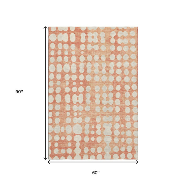 5' X 8' Coral And Beige Polka Dot Washable Area Rug With UV Protection