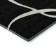 8' Black And Ivory Abstract Washable Round Rug With UV Protection