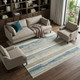6' X 9' Ivory Beige Grey Blue And Tan Abstract Power Loom Stain Resistant Area Rug With Fringe