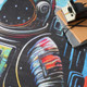 4' X 6' Black Blue And Orange Spaceman Youthful Washable Area Rug