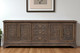 106" Brown Distressed Solid Wood Carved Floral Three Drawer Sideboard with Four Doors