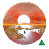 A circular button badge featuring an artistic landscape with mountains, a setting sun, and a small sailboat on water.