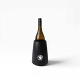 A black wine cooler holds a bottle of wine, featuring a circular logo on the front.