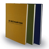 Three notebooks in gold, green, and navy blue, featuring a logo on the cover.