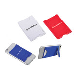 A red, white, and blue mobile stand and card holder, designed to attach to a phone, featuring a logo.