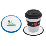 A blue and white coaster beside a coffee cup with a black lid, featuring a logo.