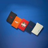 A collection of five Minichroma A6 Notebooks in various colours: red, orange, blue, navy, and white, each featuring a logo.