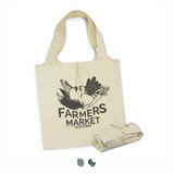 A cream-coloured foldaway tote bag featuring a graphic design and a logo, neatly rolled and tied next to it.